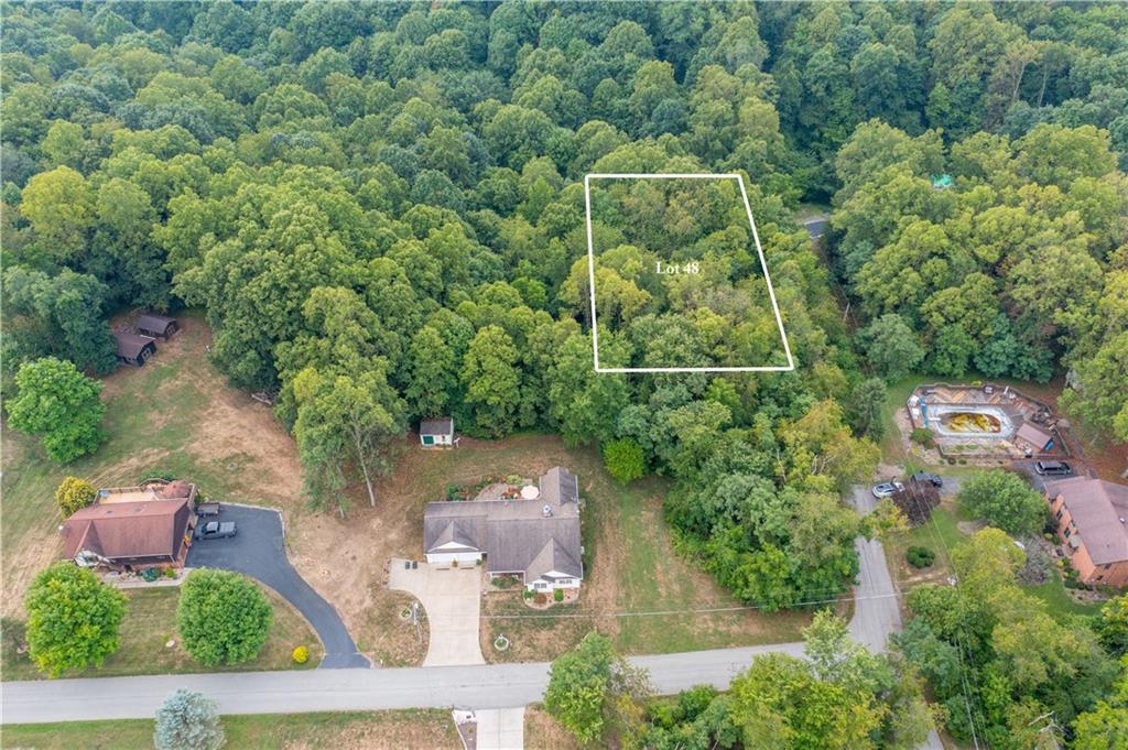 an aerial view of a house with yard