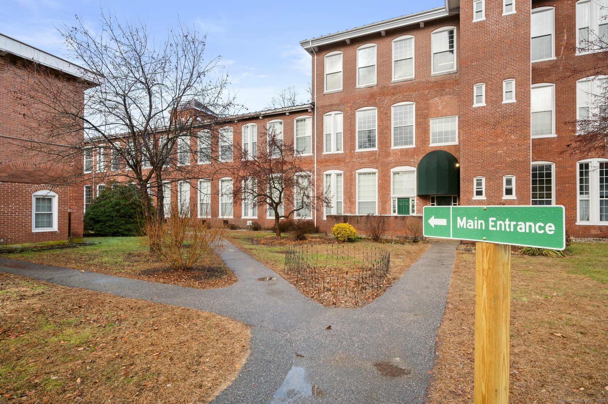 a view of a brick building next to a yard