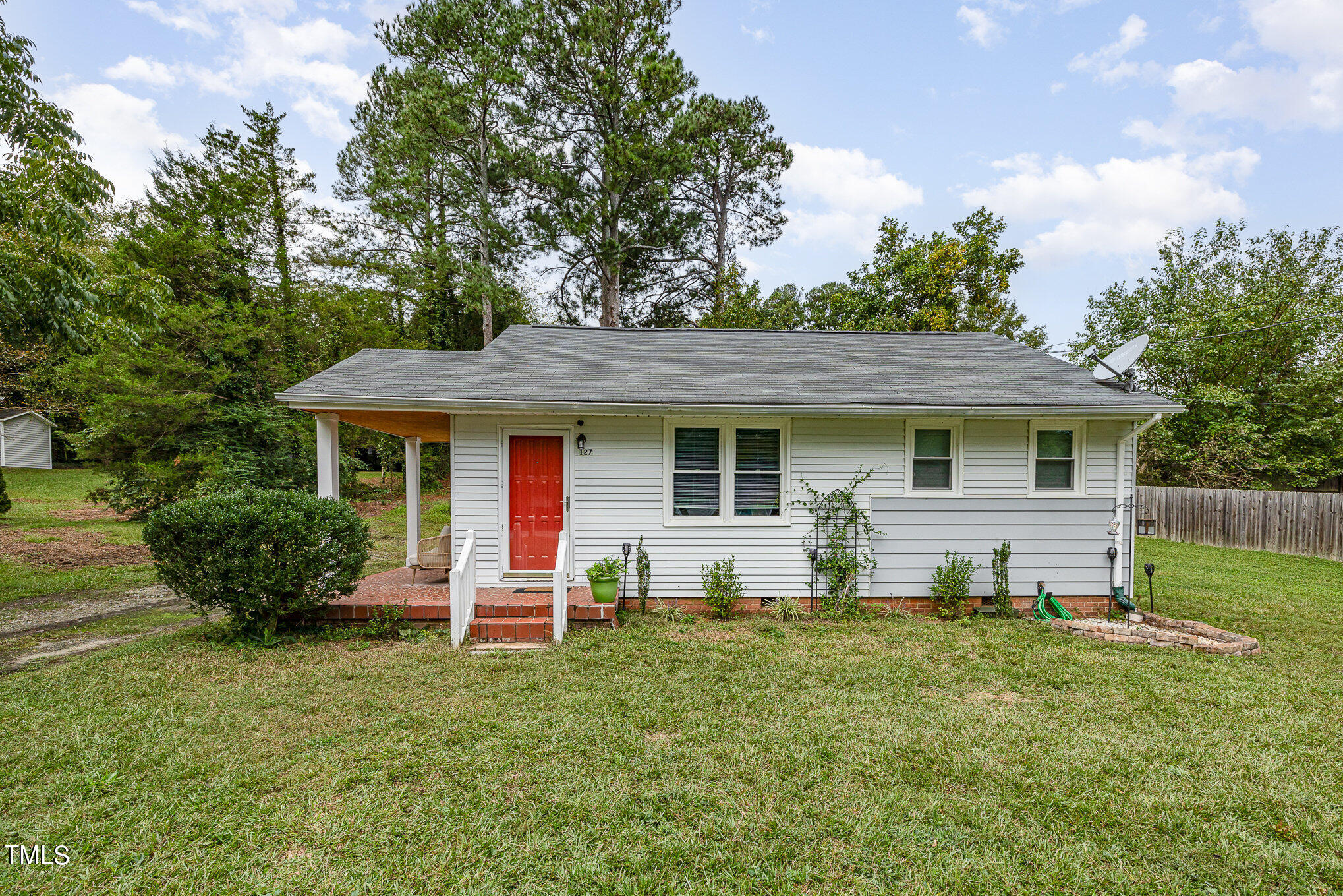 a view of a house with a yard and sitting area