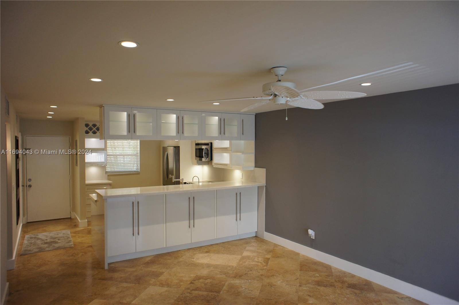 a large kitchen with kitchen island a sink stainless steel appliances and cabinets