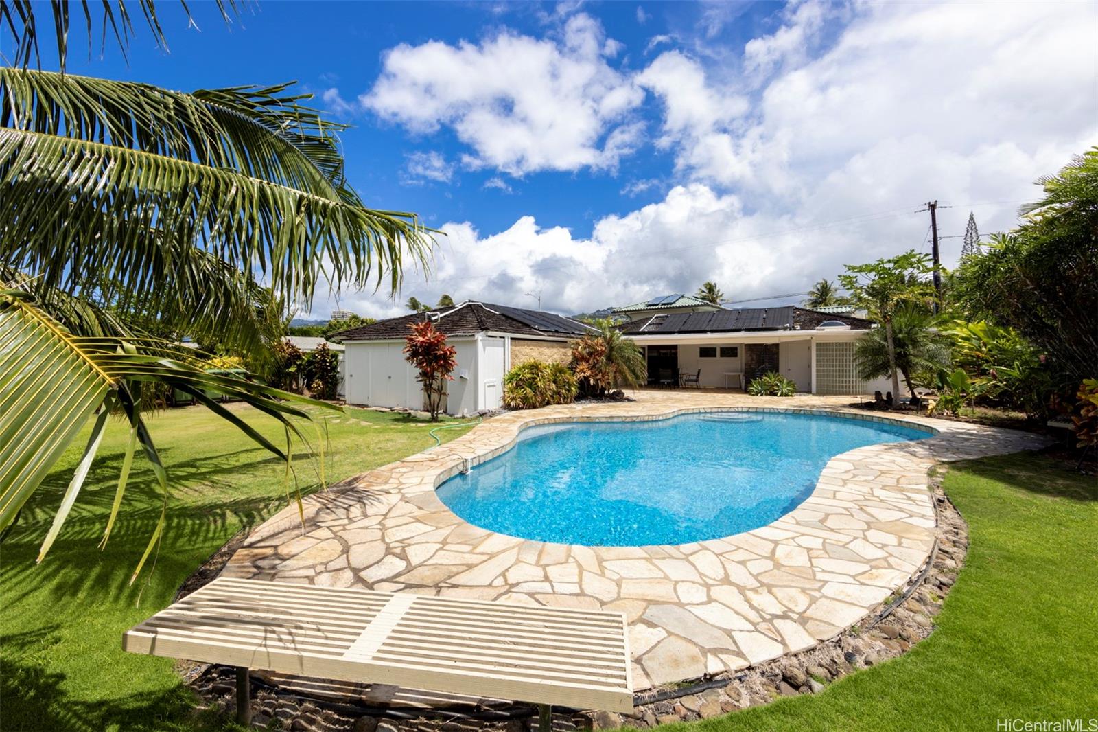 a swimming pool with outdoor seating and yard