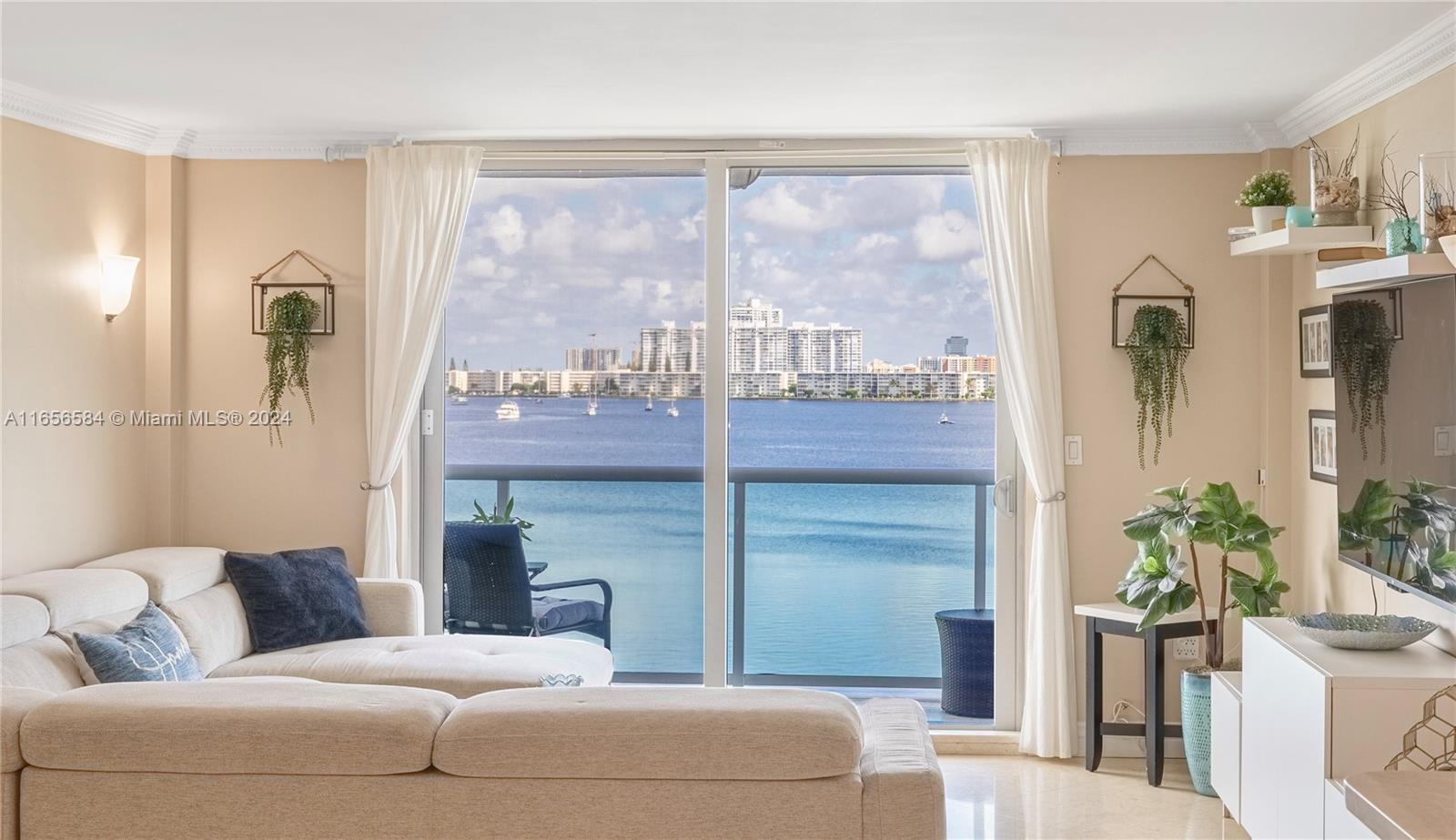 a living room with furniture and a floor to ceiling window