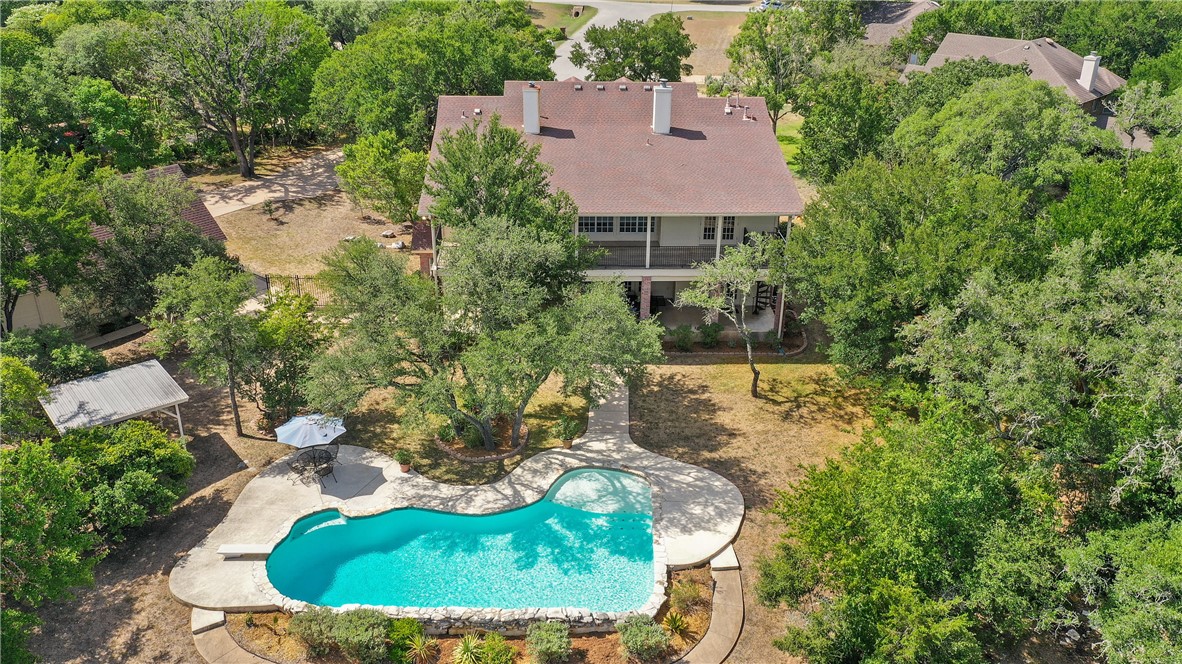 an aerial view of a house with yard swimming pool and outdoor seating