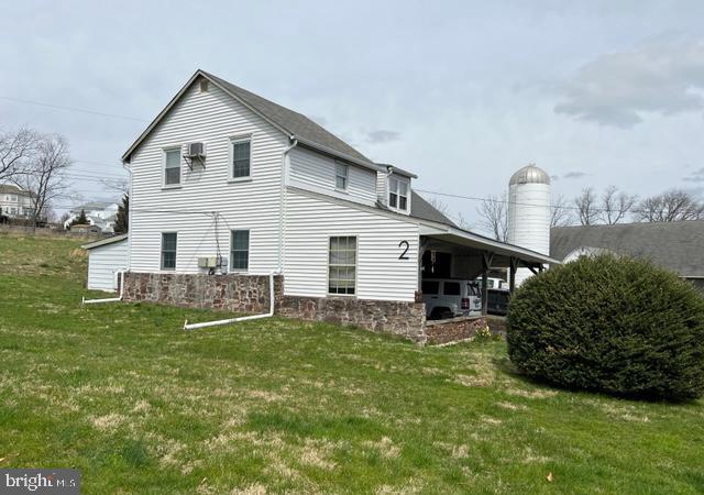 a view of a house with a yard and sitting area