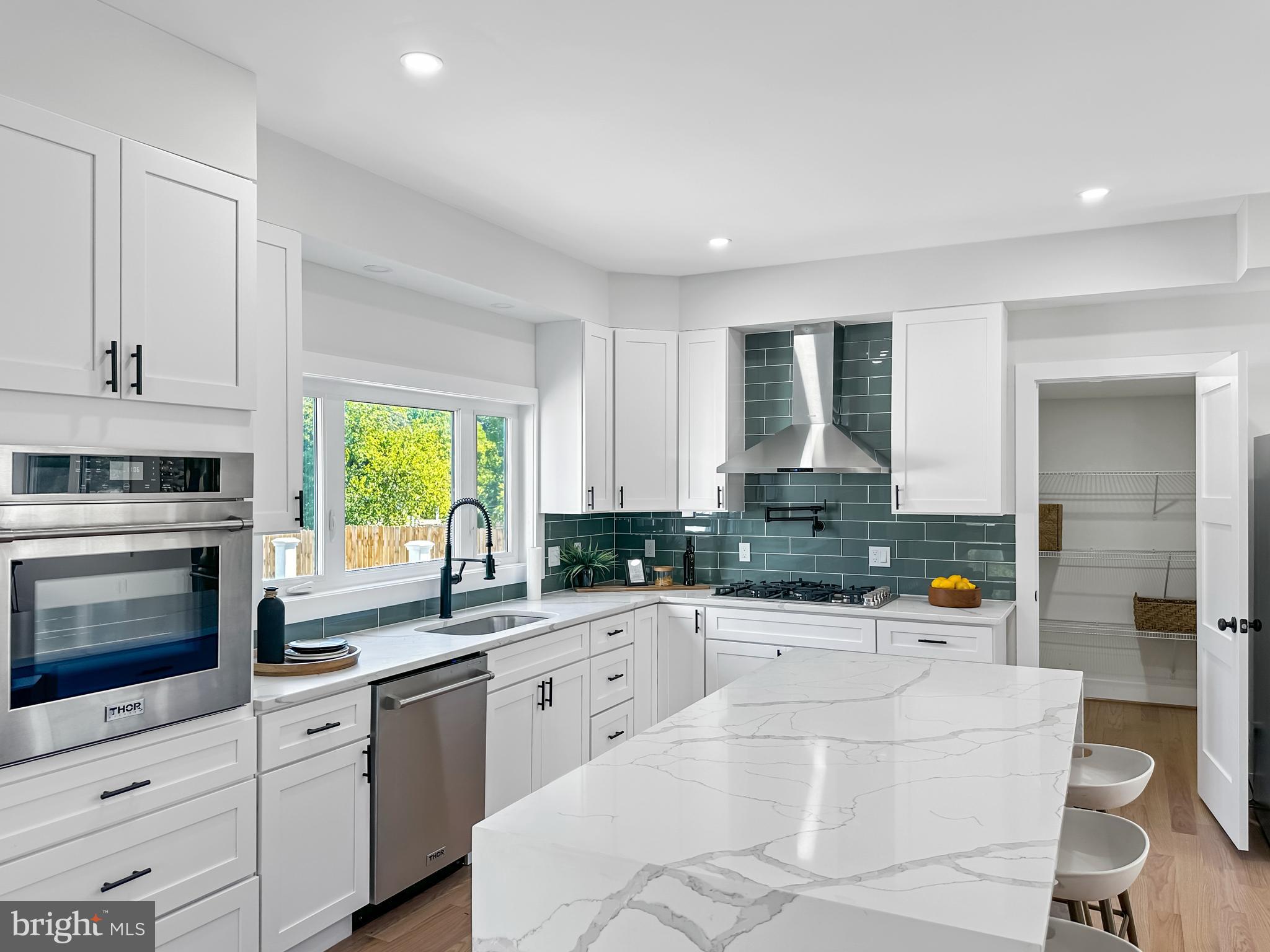 a kitchen with a sink a stove and cabinets