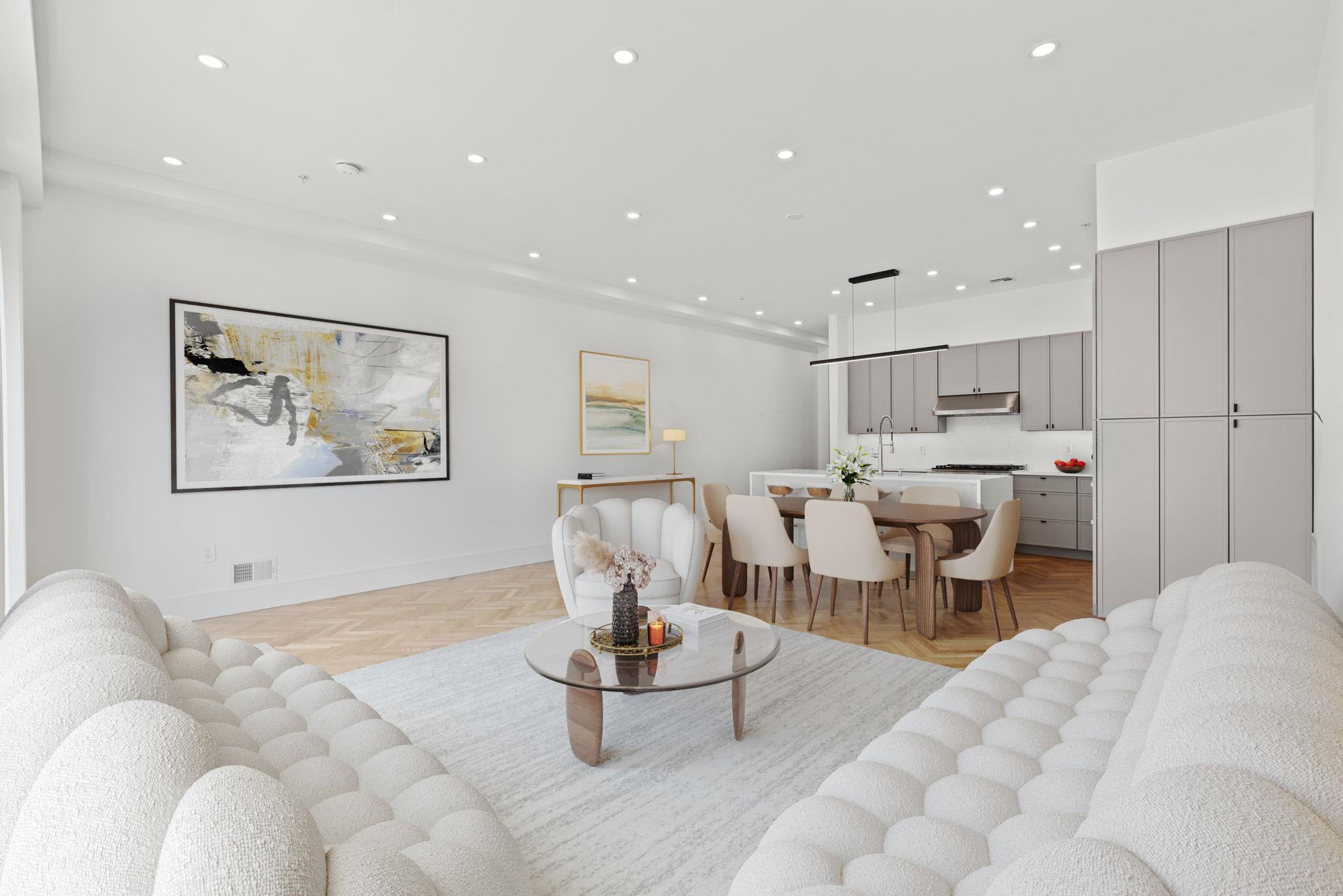 a living room with furniture a rug and white walls