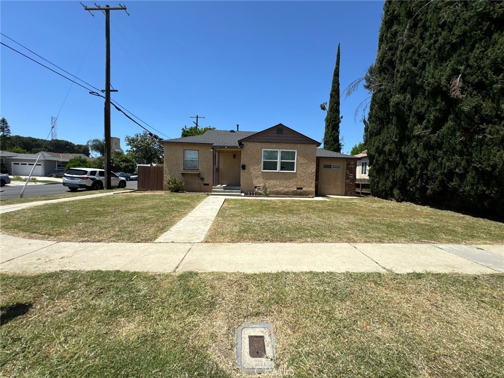 a view of a house with a yard and sitting area