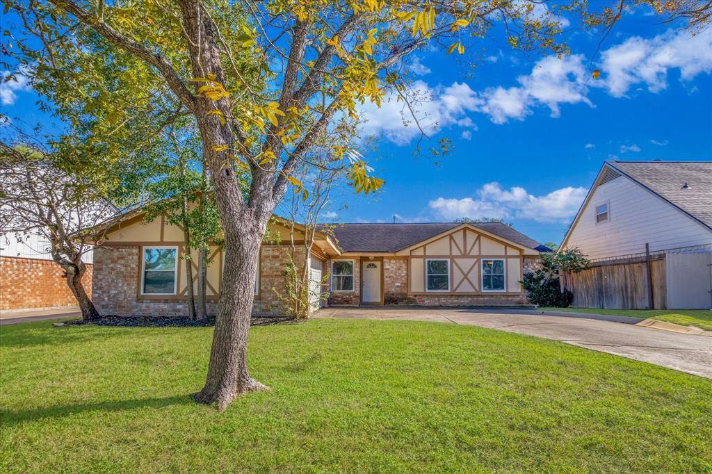 a front view of a house with a big yard