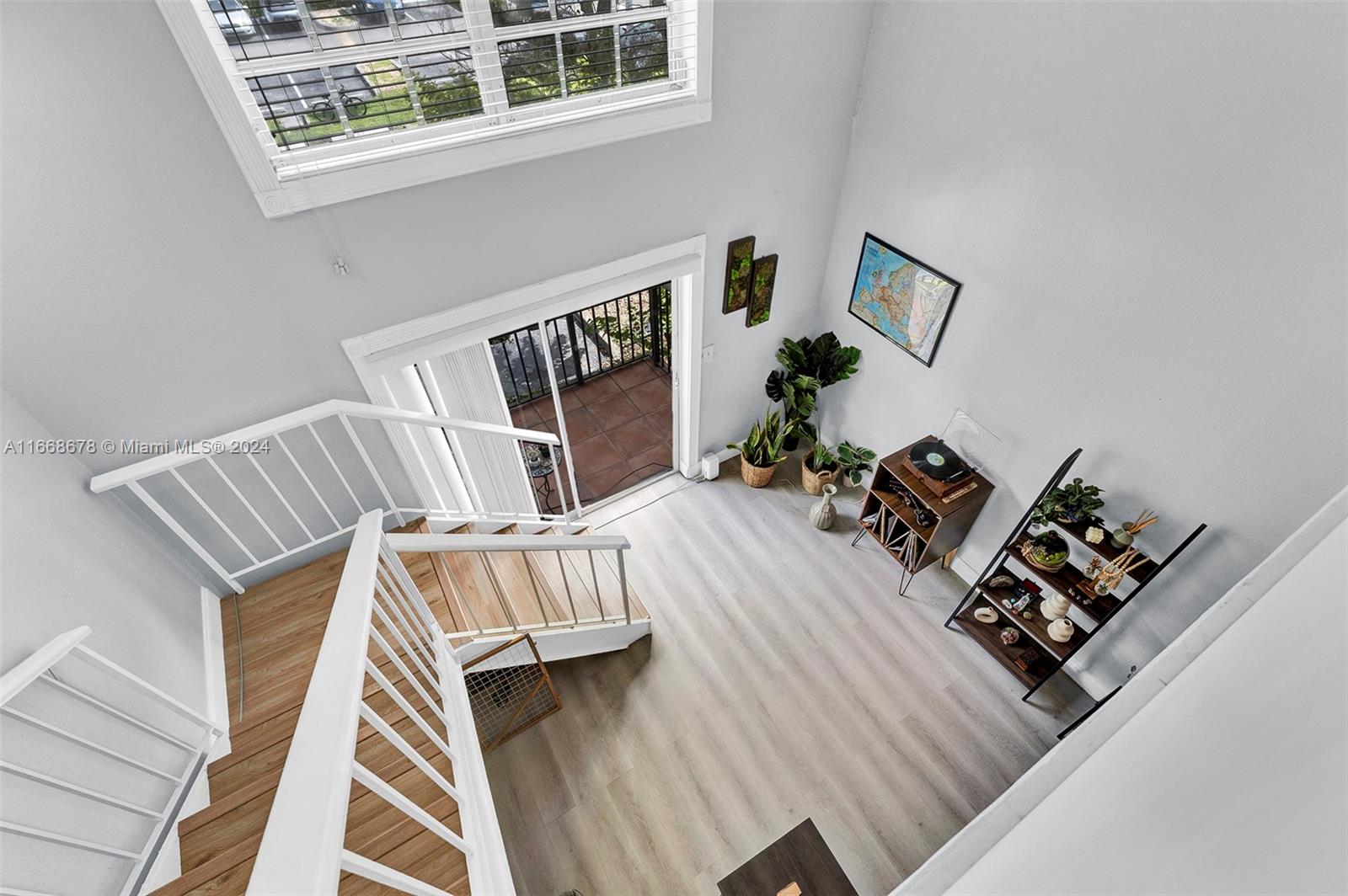 a view of front door with furniture and wooden floor