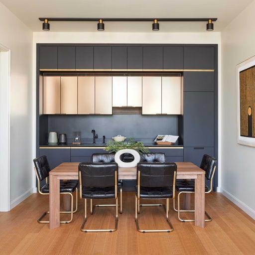 a kitchen with a dining table chairs cabinets and a window