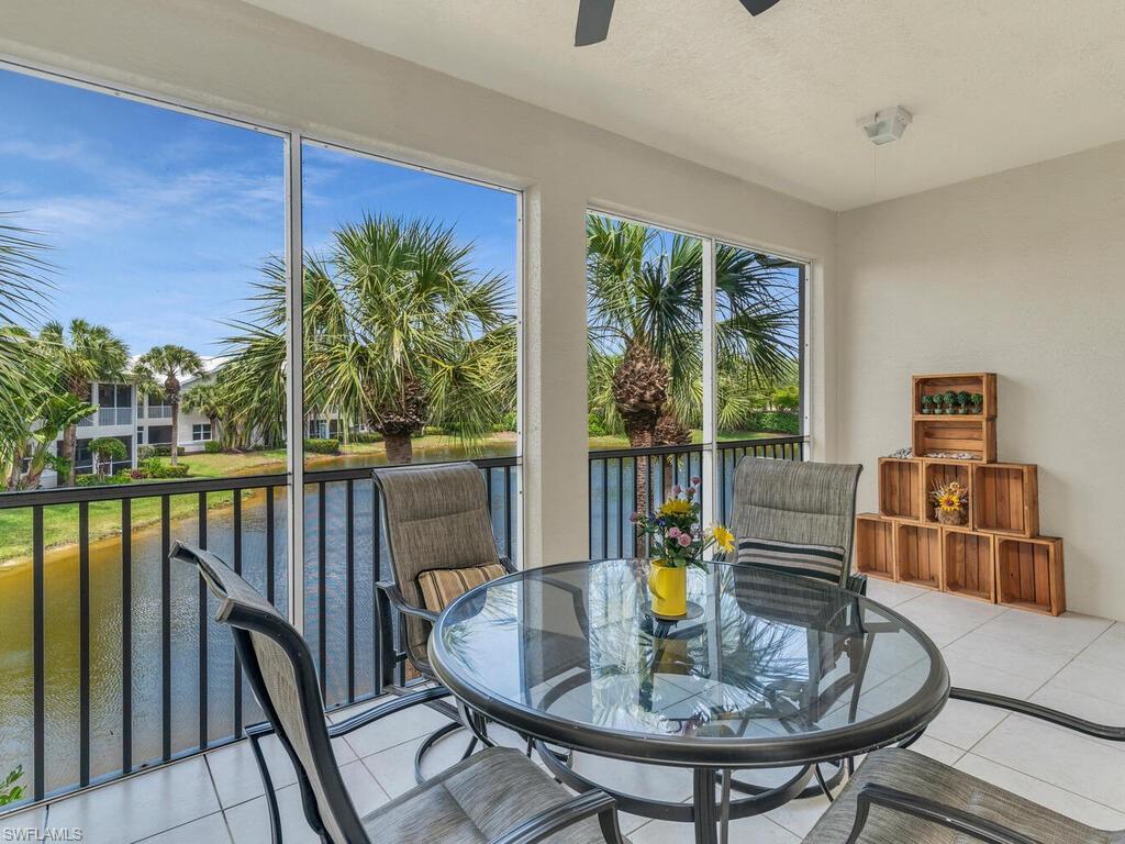 Sunroom / solarium featuring a water view