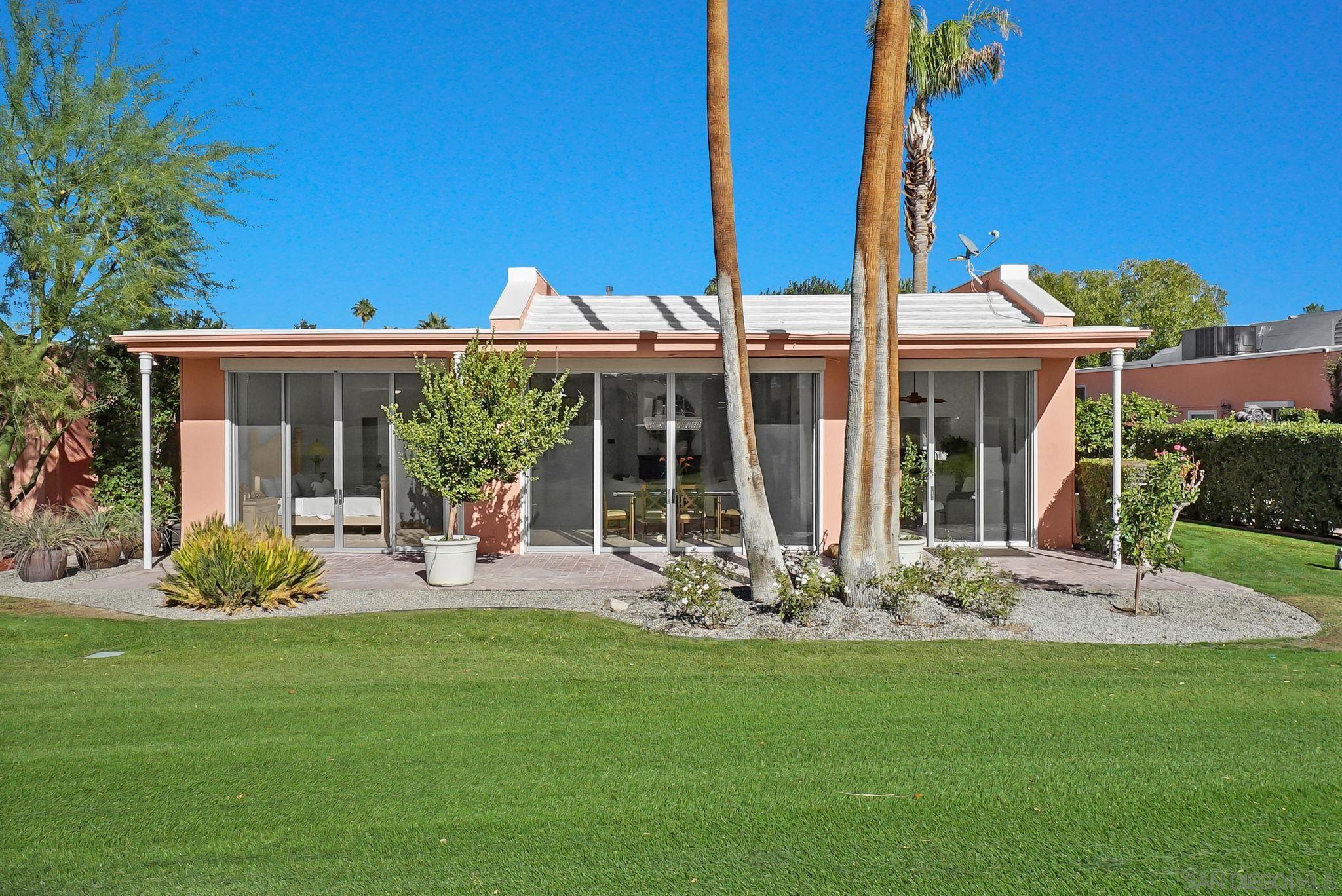 a front view of a house with a garden and patio