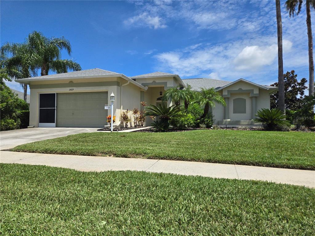 a front view of a house with a yard and garage