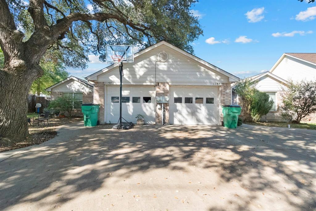 a view of a large house with a tree in front