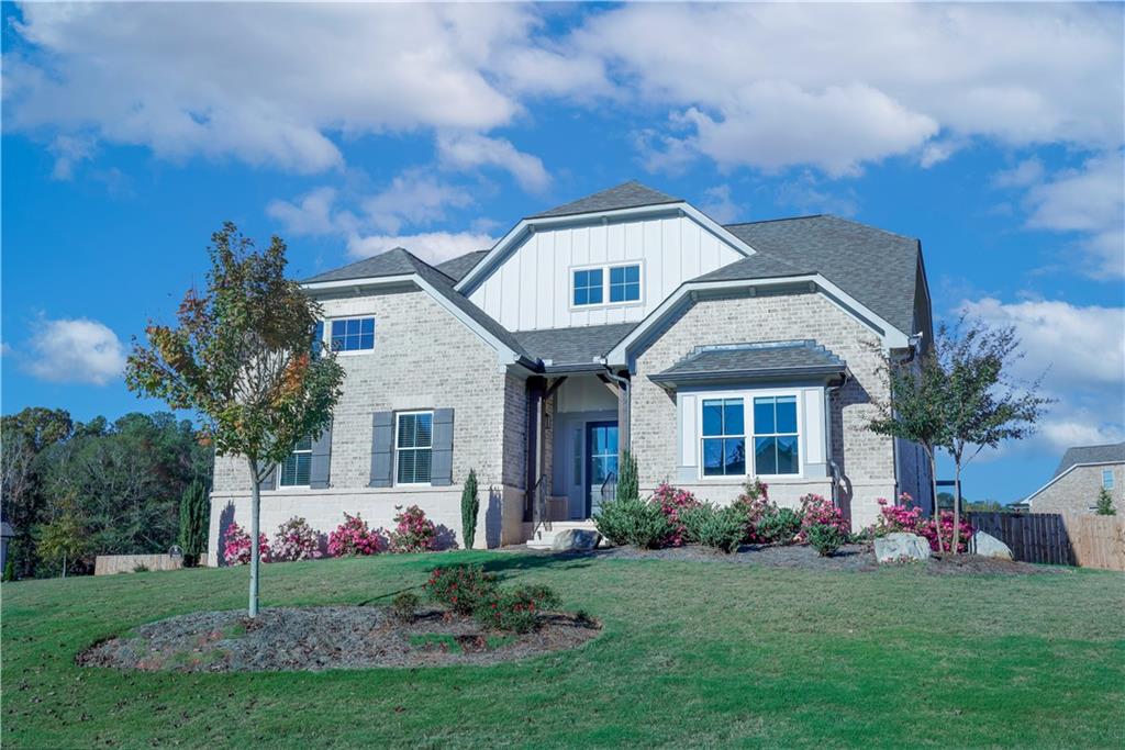 a front view of a house with a garden