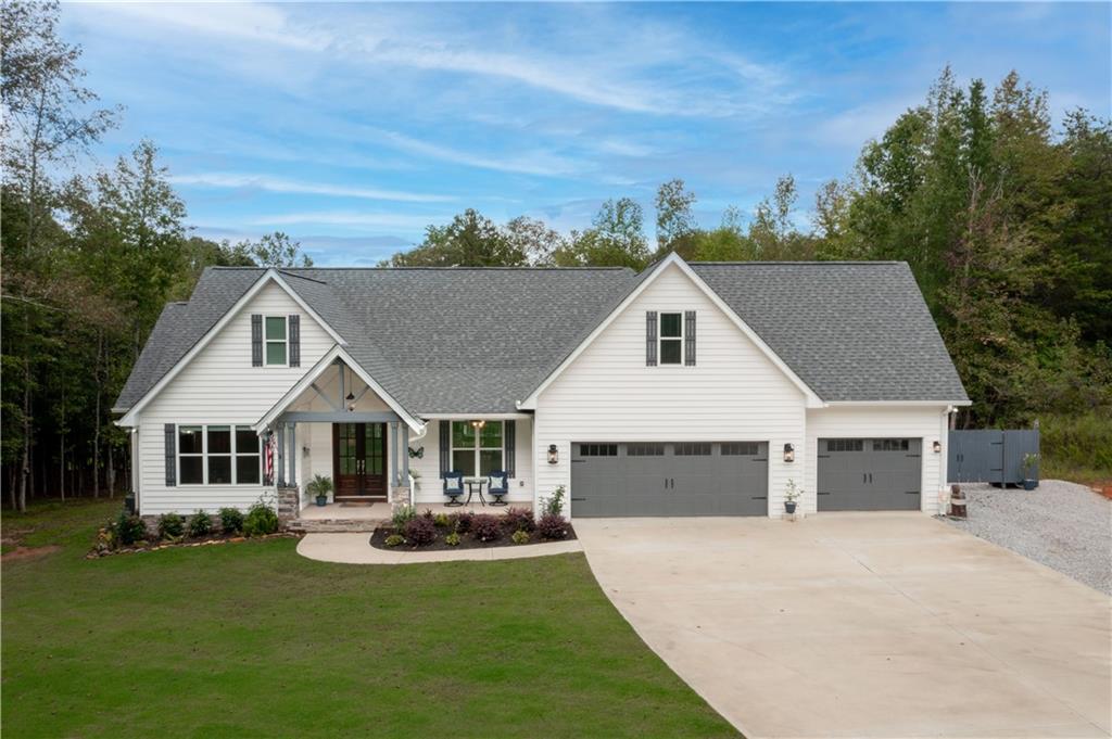 a view of a house with a yard and a garage