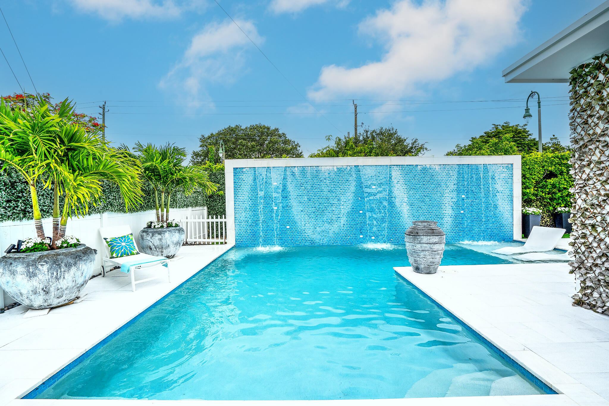 a view of backyard with swimming pool and seating space