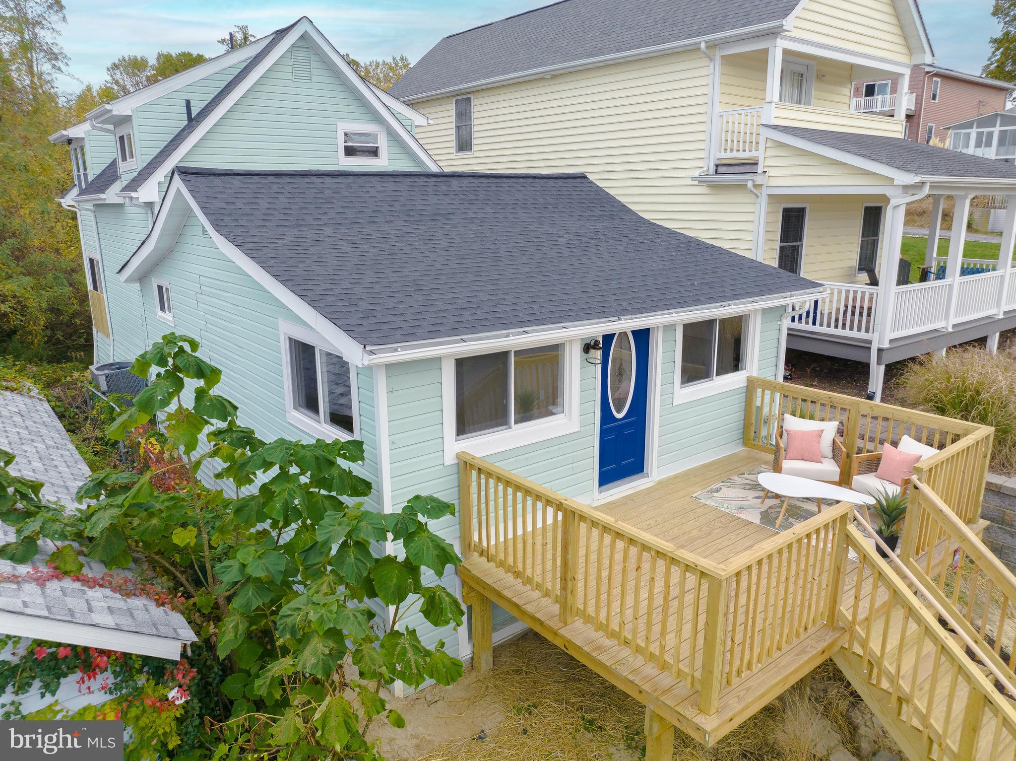 a aerial view of a house with a deck and furniture