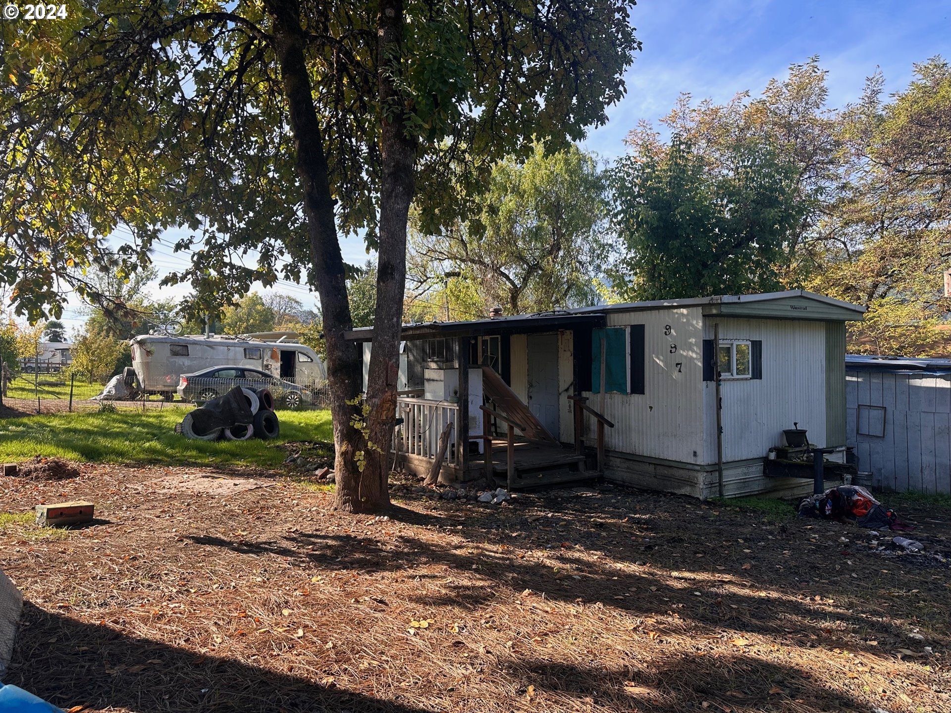 a view of a barn in the middle of a yard