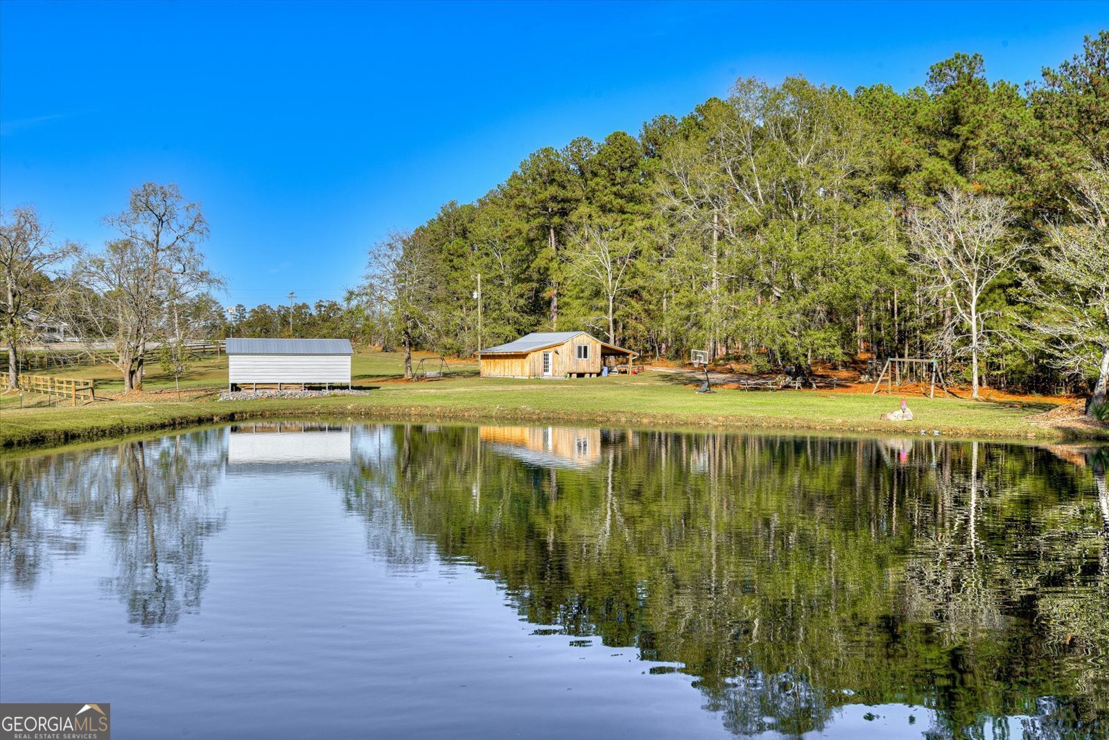 a view of a lake with houses in front of it