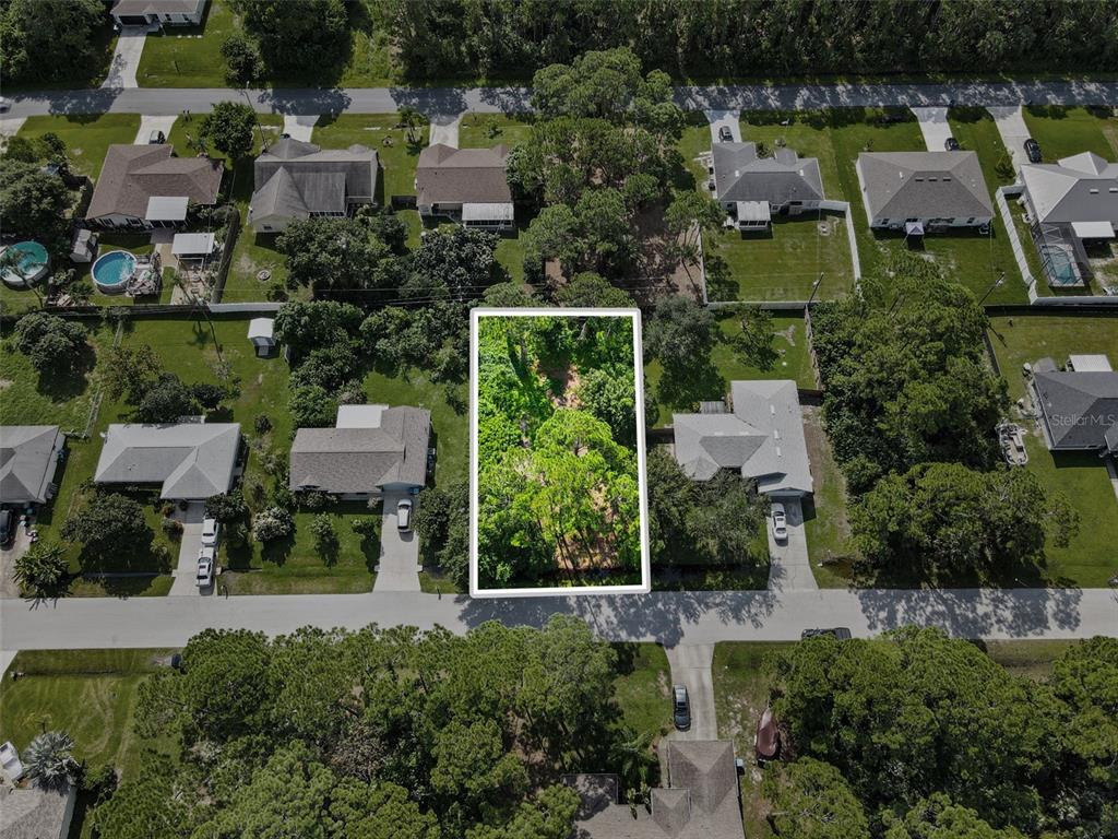 an aerial view of residential houses with outdoor space and swimming pool