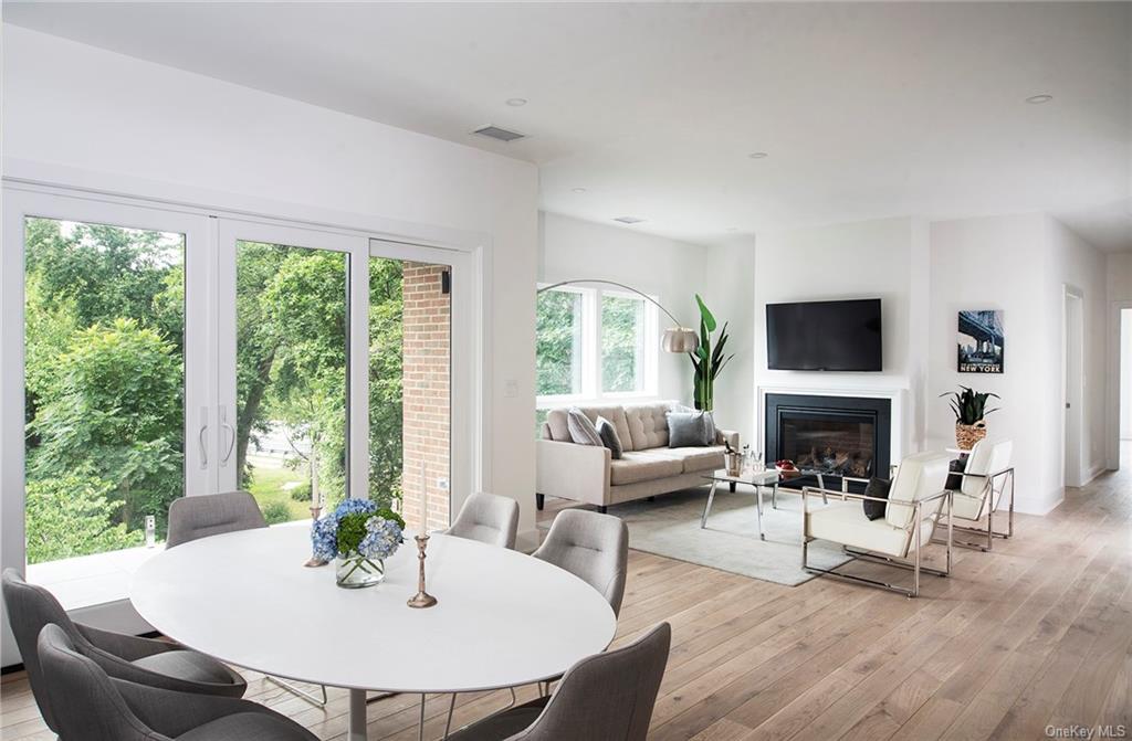 a living room with furniture a fireplace and a large window