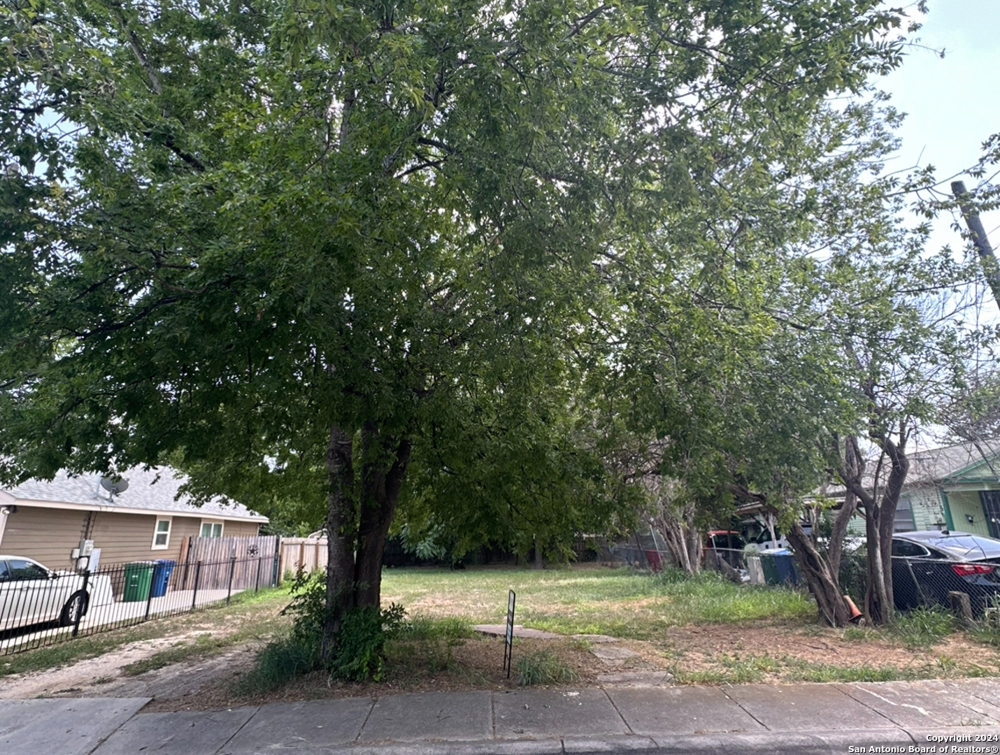 a front view of a house with a tree