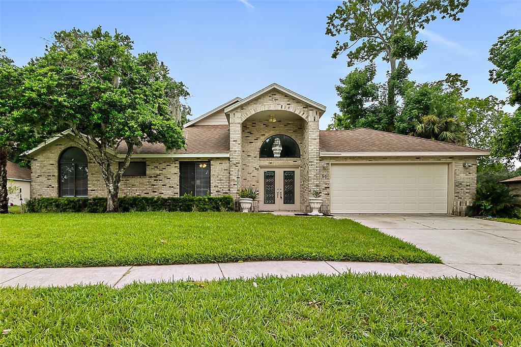 a front view of a house with a garden and yard