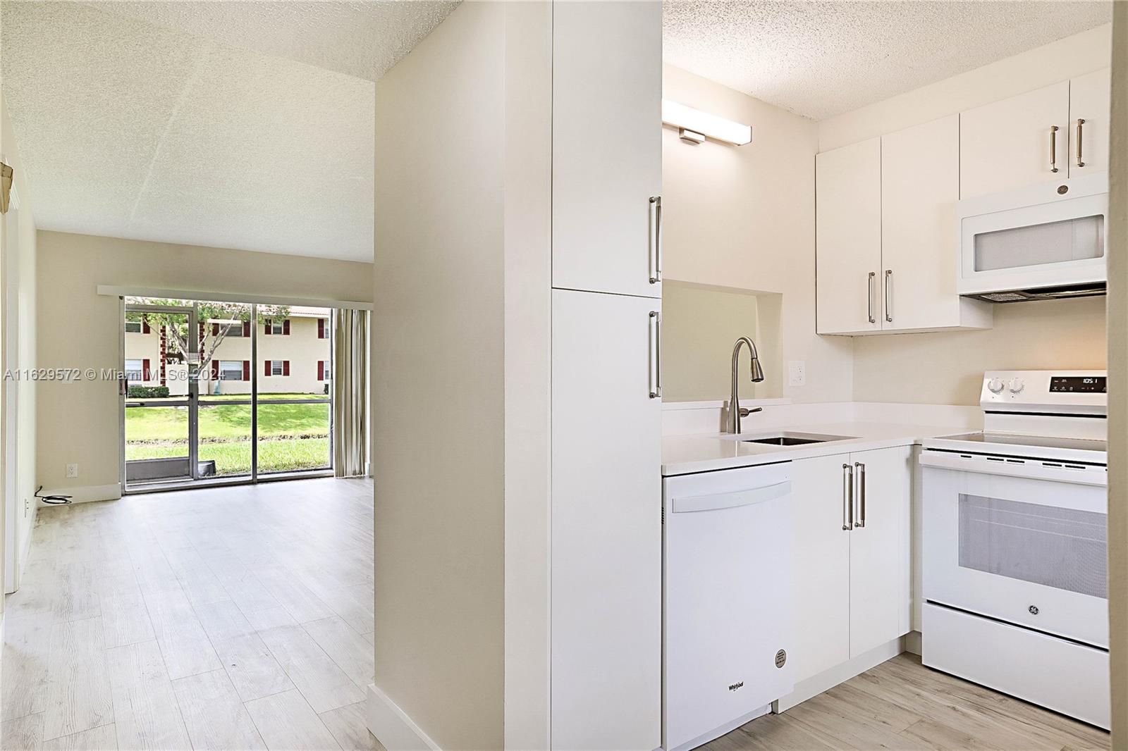 a kitchen with a sink a stove and cabinets