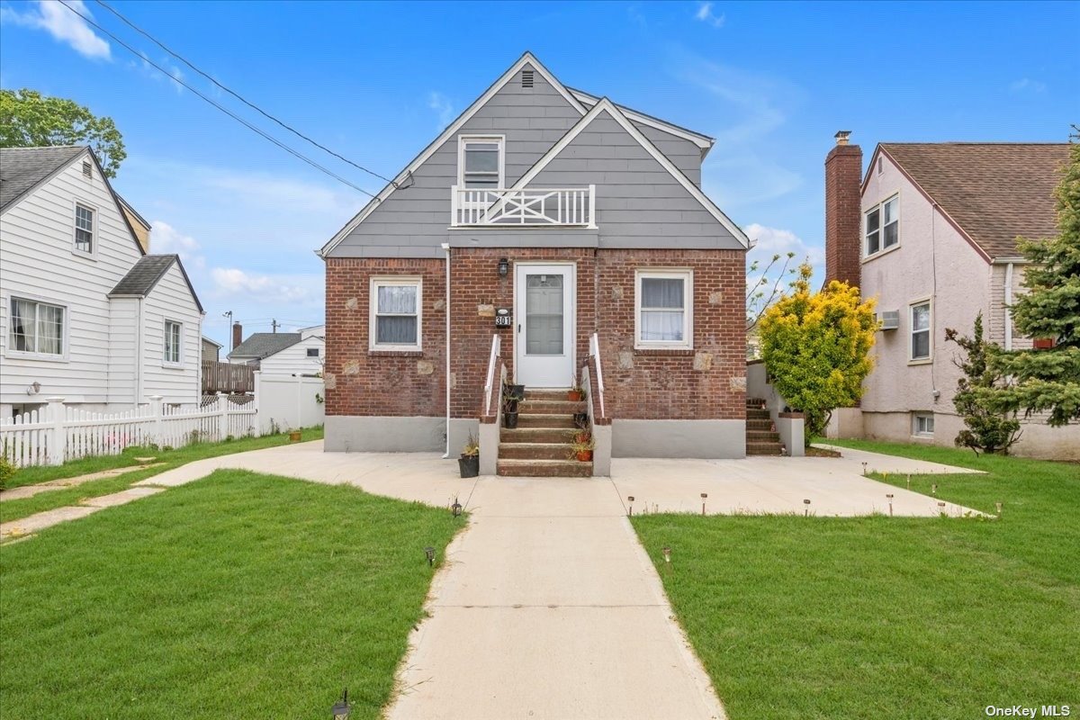 a front view of a house with a yard and porch