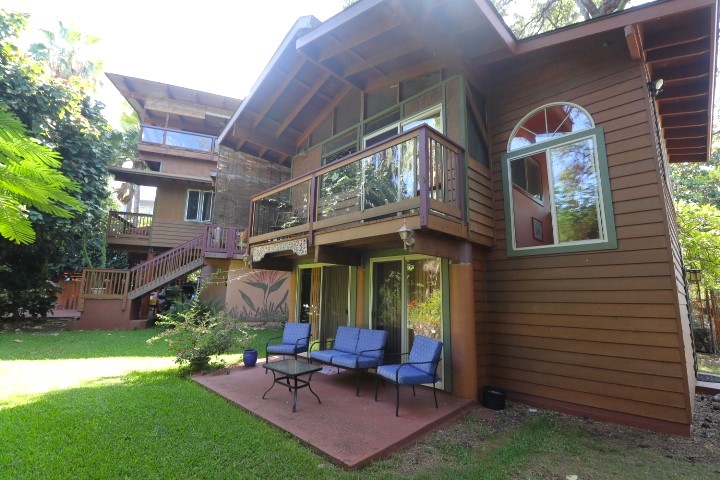 a view of a patio with table and chairs with wooden fence and plants