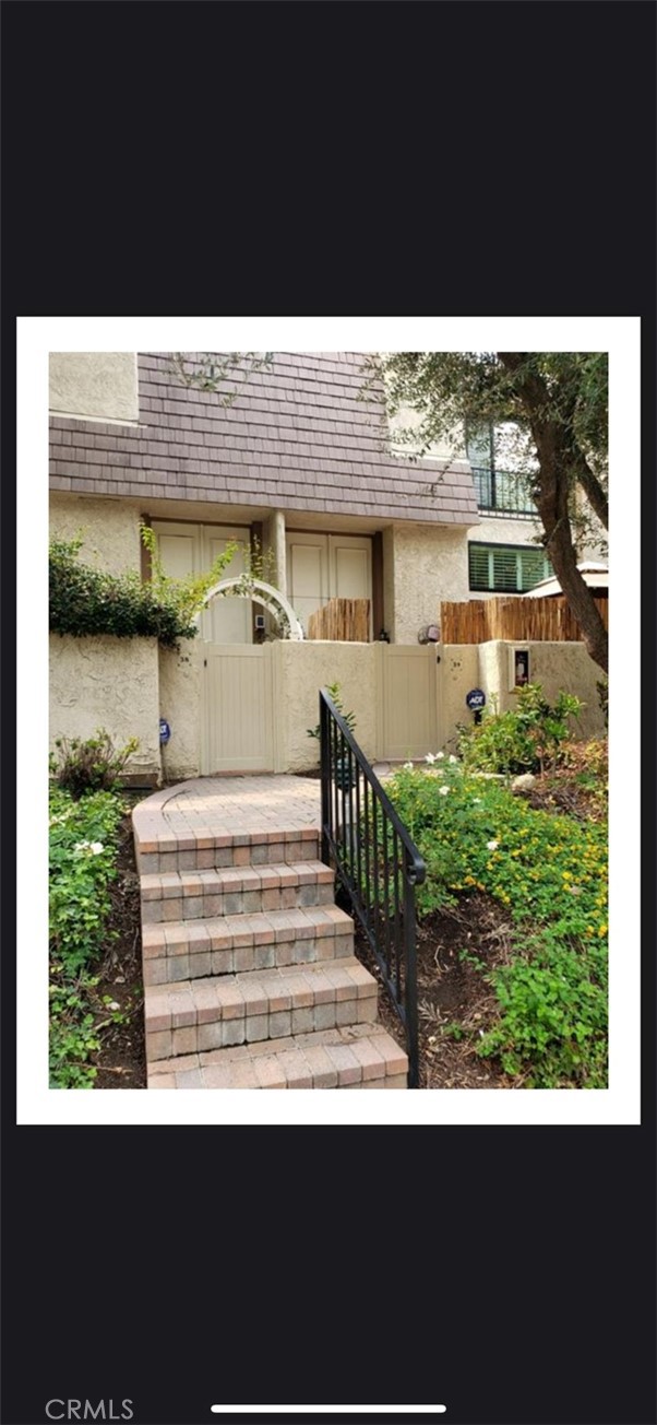 a view of a porch with wooden floor and fence