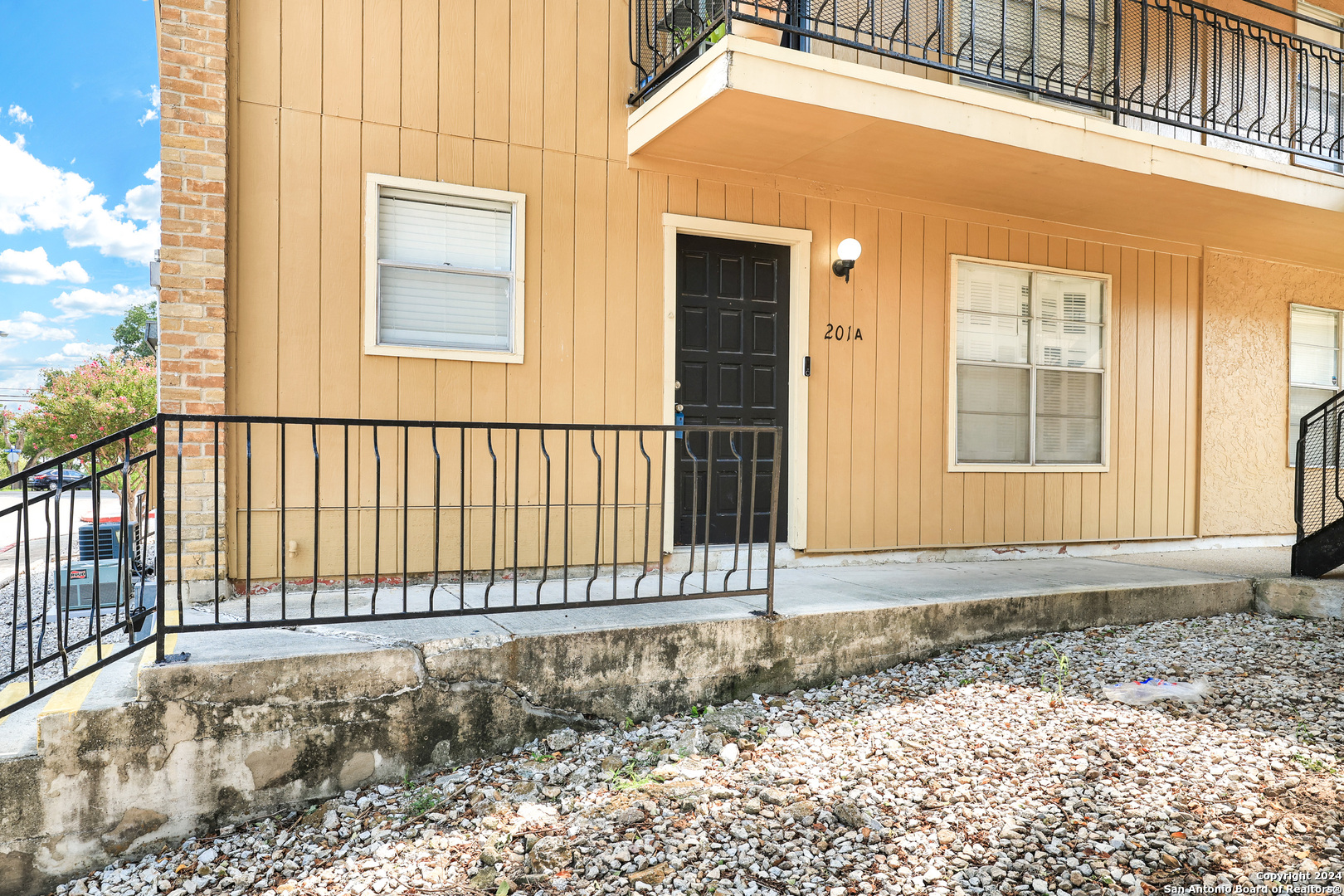 a view of a house with a small yard