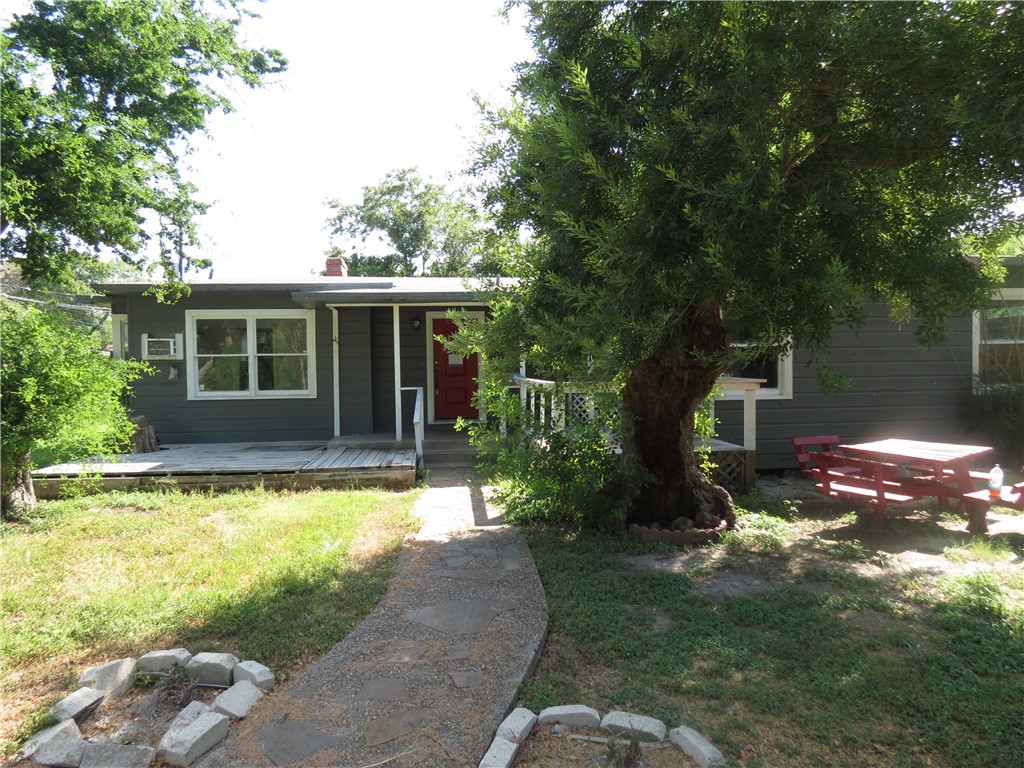 a view of a house with backyard porch and sitting area