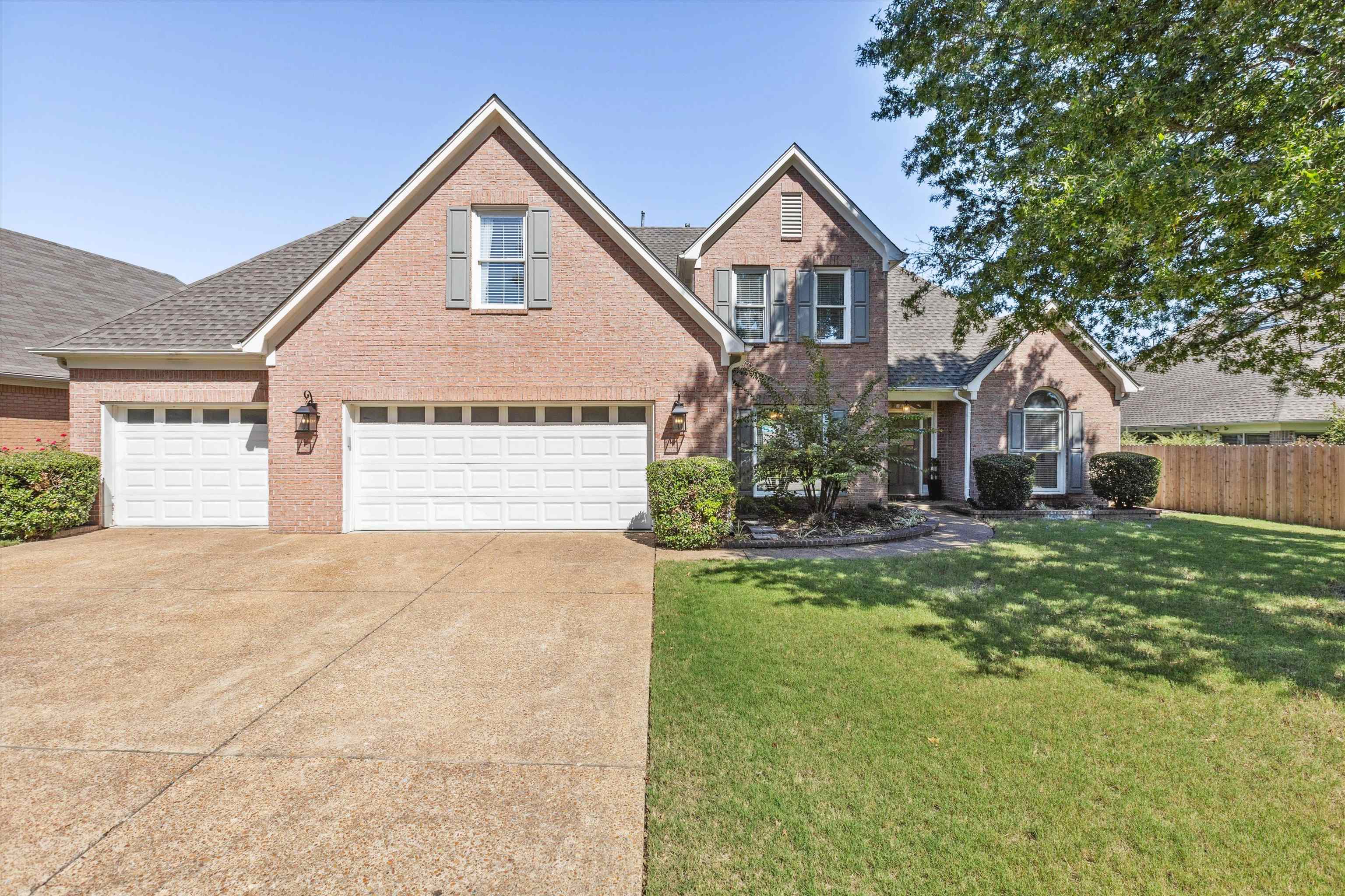 View of front of property with a front lawn and a garage