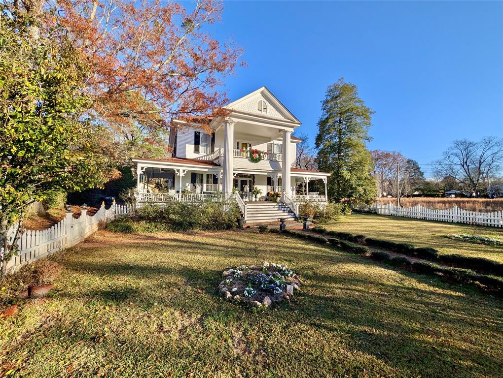 a front view of a house with a yard swimming pool and outdoor seating