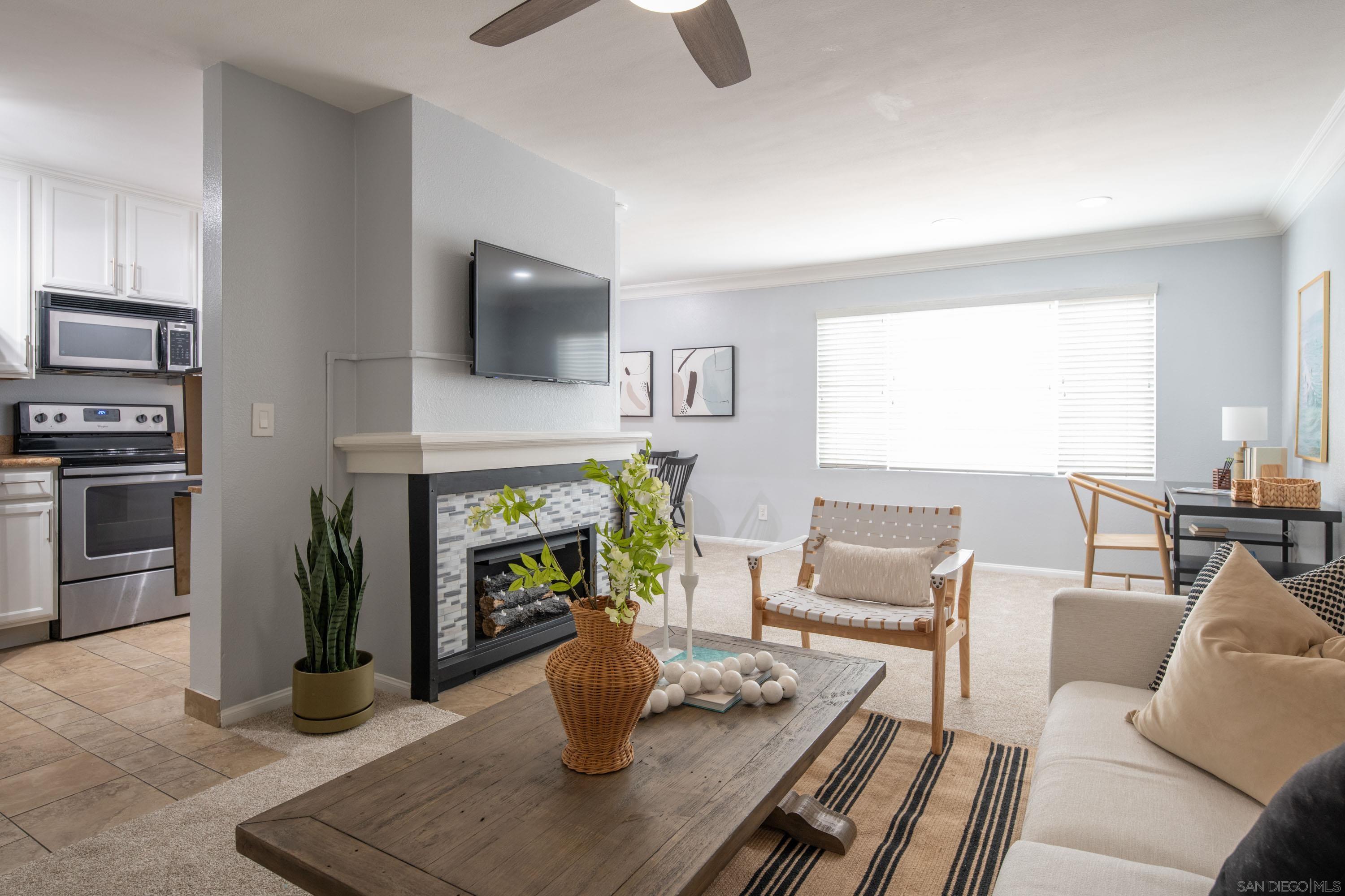 a living room with furniture a fireplace and a flat screen tv