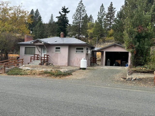 a front view of a house with a yard and a garage