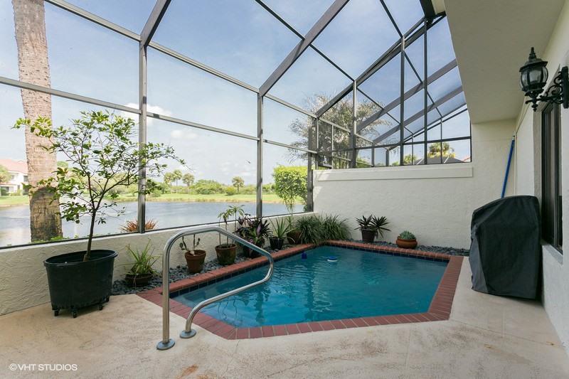 a room with pool table and windows