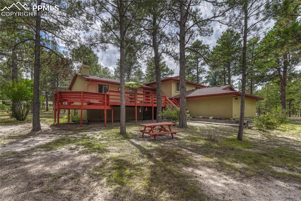 This custom 4-level stucco home is set on 5.02 acres, horse-zoned, in the peaceful Wildwood Village neighborhood of Black Forest.