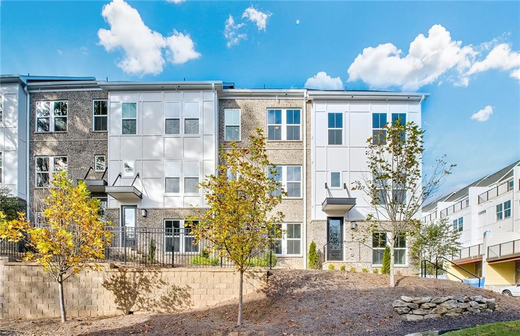 a front view of a residential apartment building with a yard