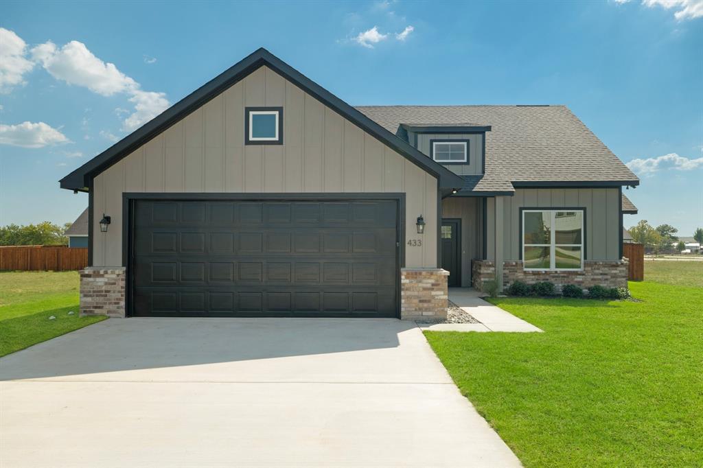 a front view of a house with a yard and garage