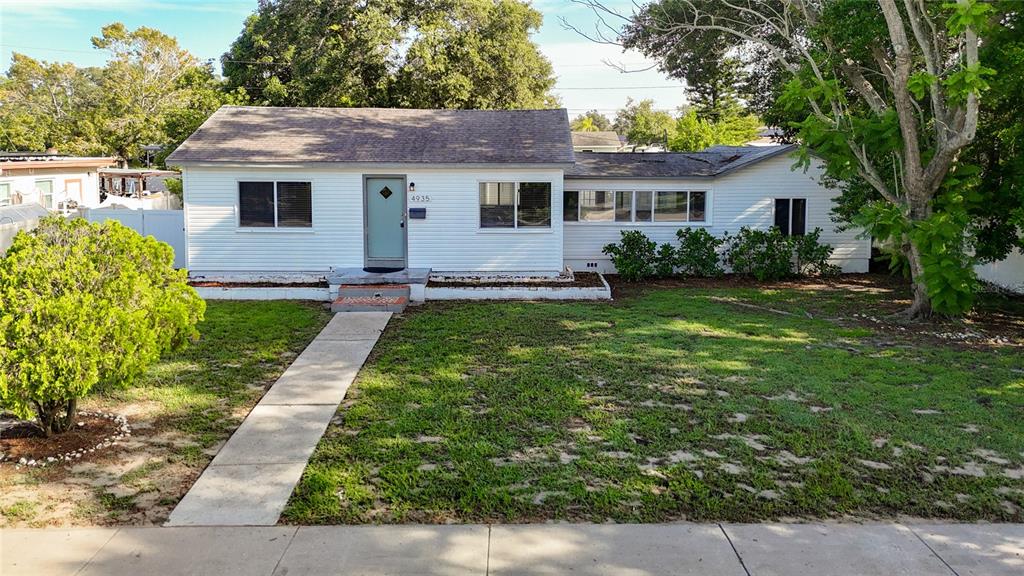 a front view of house with yard and green space