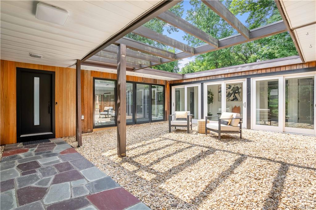 a view of a house with backyard porch and sitting area