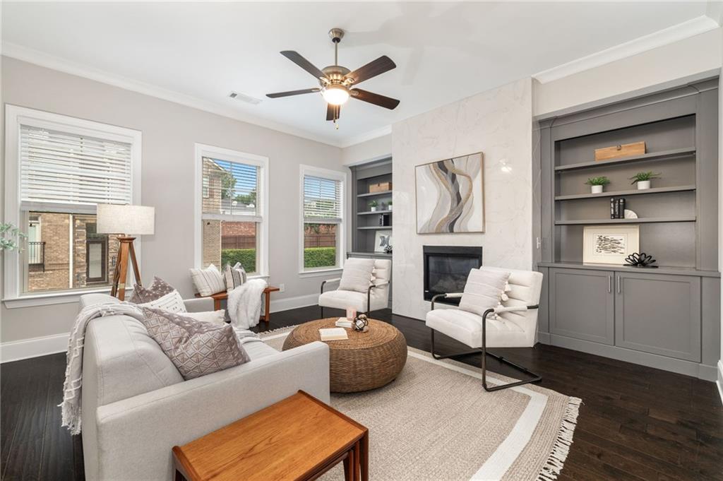 a living room with furniture fireplace and a window