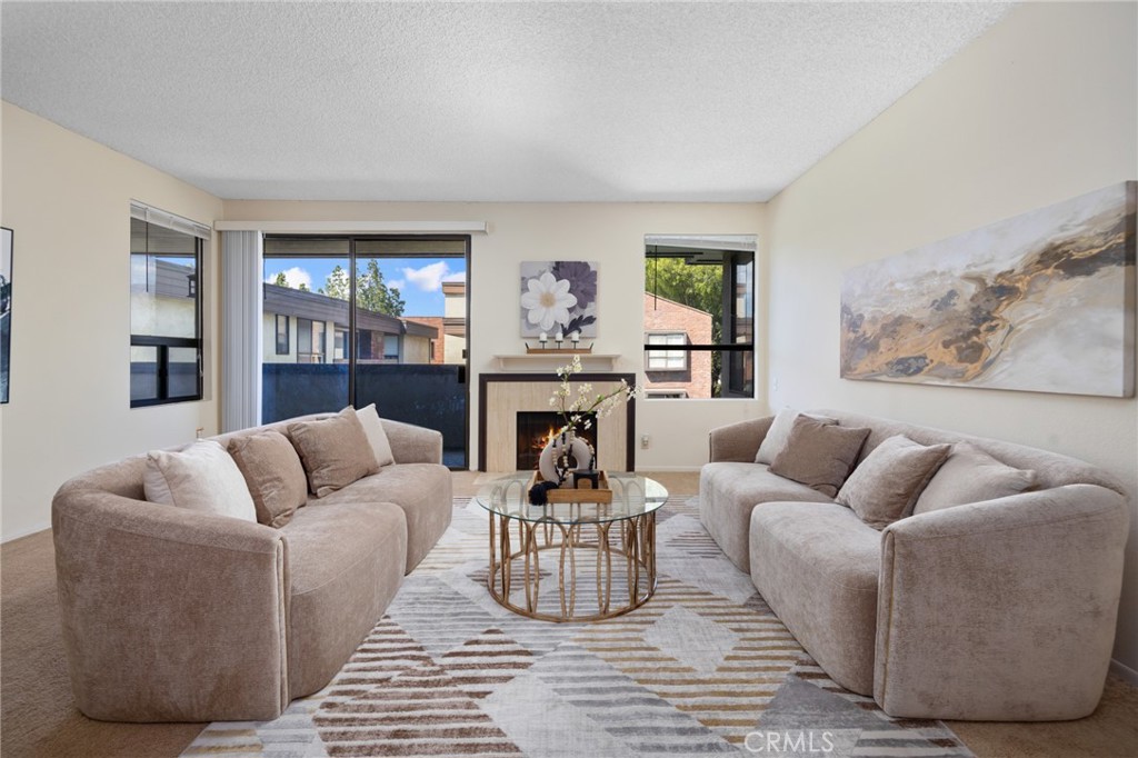 a living room with furniture and a fireplace