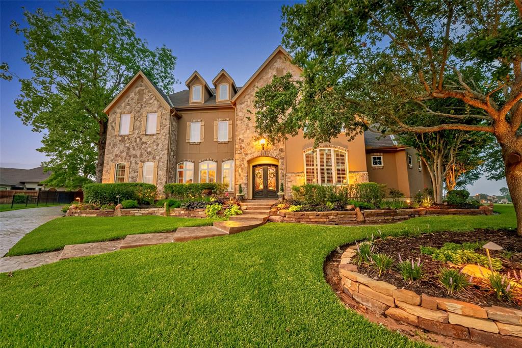 a front view of a house with a garden and patio