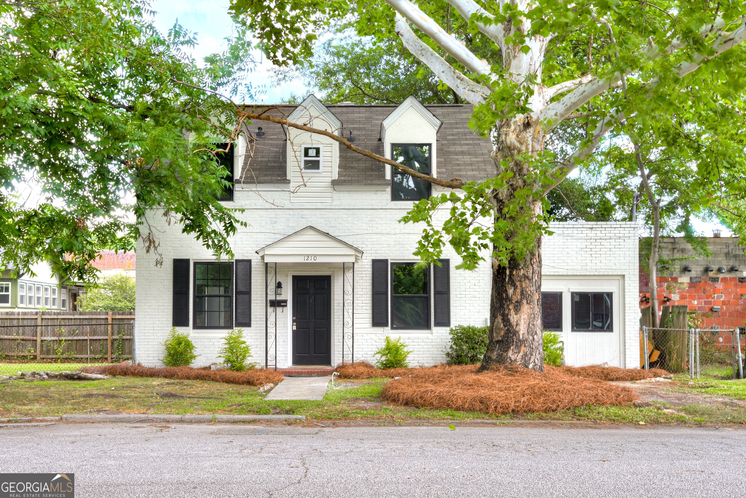 a front view of a house with garden