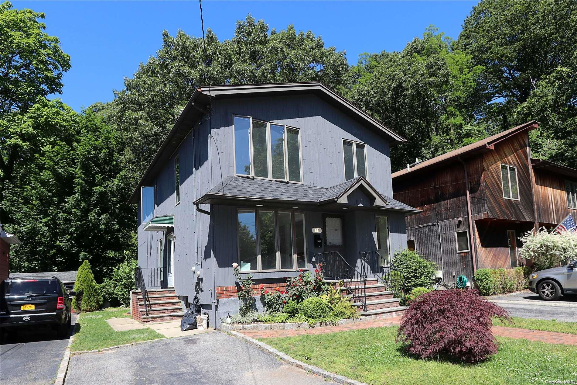 a front view of a house with garden