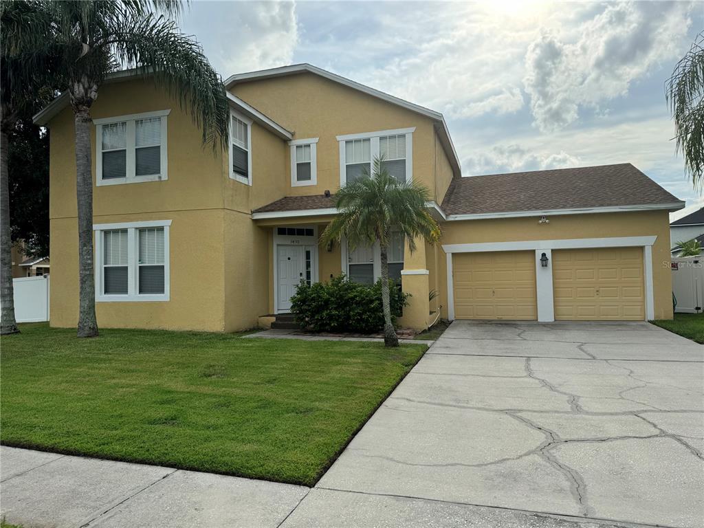 a front view of a house with a yard and garage